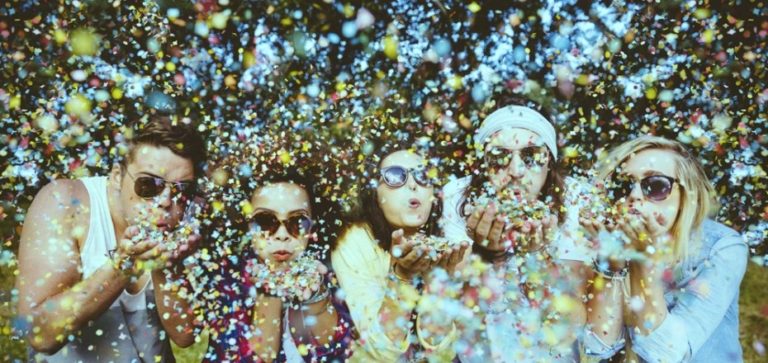 Hipsters blowing confetti